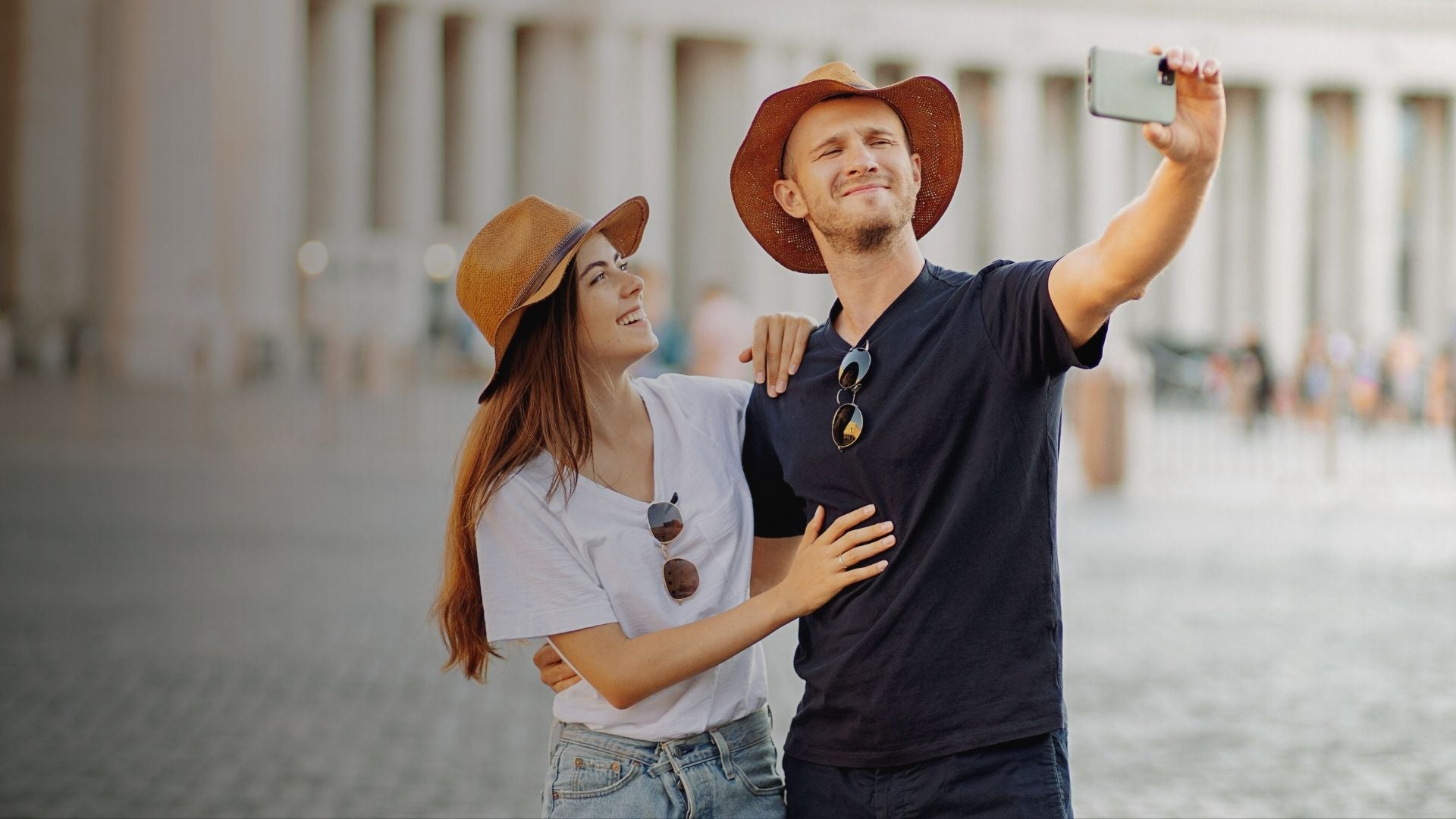 Couple taking a selfie outdoors with a blurred background