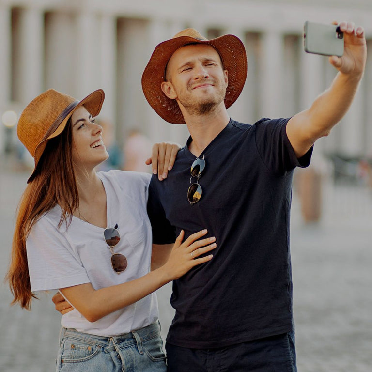 Couple taking a selfie outdoors with a blurred background